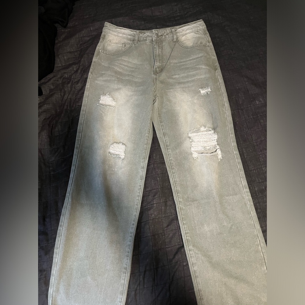 Pale washed green ripped jeans